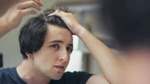 topical serum for hair loss applied by a young man